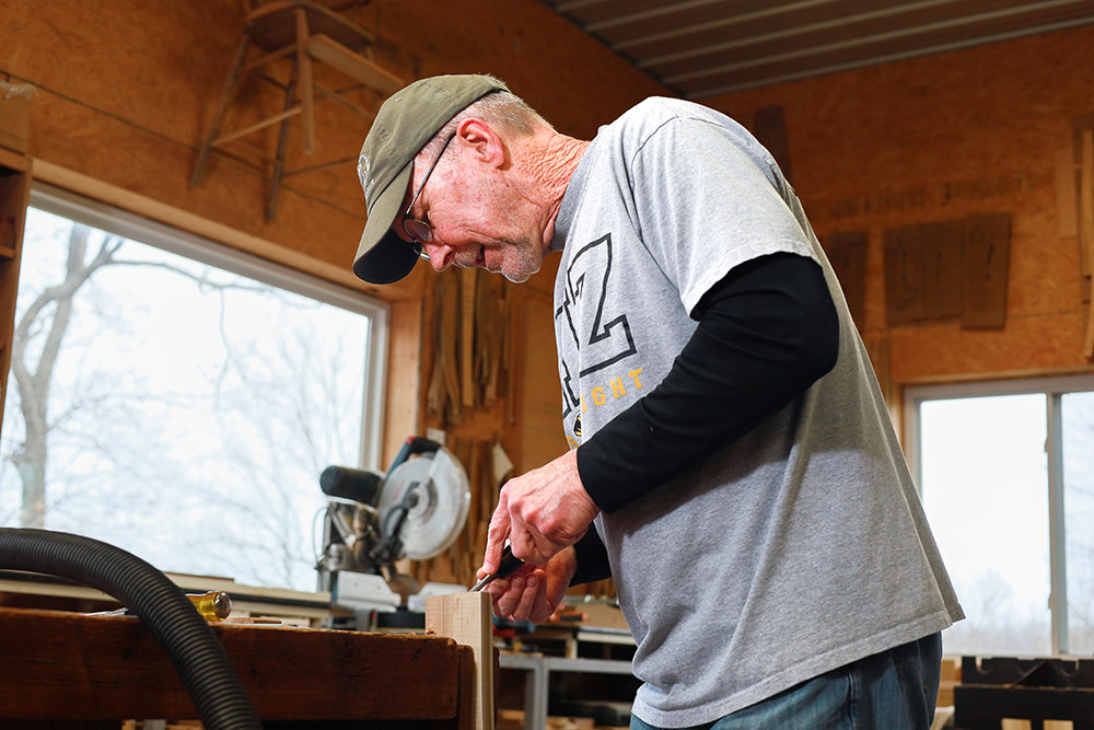Al Boswell is in his Mount Vernon workshop, where he makes custom furniture and is working on a new design for a low-back chair.